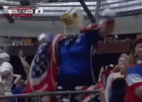 a man wearing a bald eagle mask is standing in a crowd .