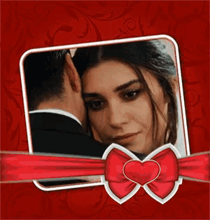 a picture of a man and woman in a frame with a heart shaped bow