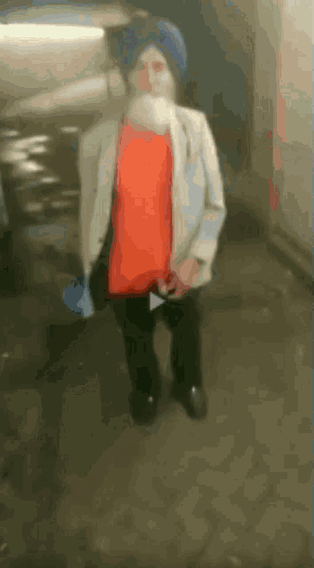 a man wearing a turban and a red shirt