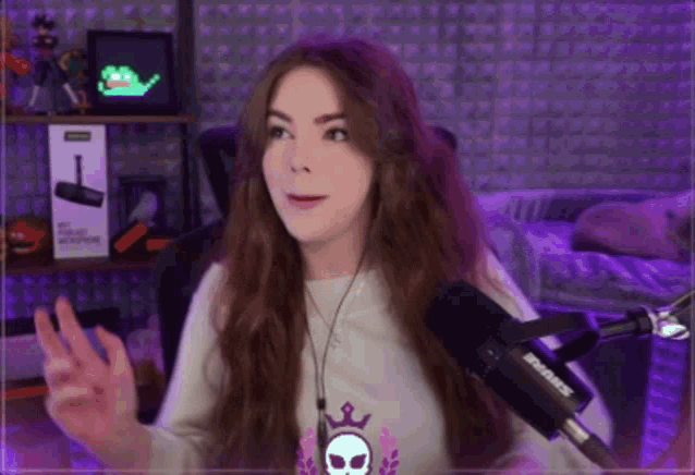 a woman talking into a shure microphone in a room