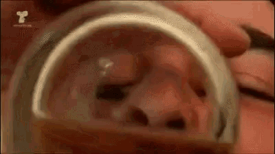 a close up of a person 's mouth with a condom in it