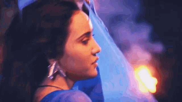 a close up of a woman in a blue dress