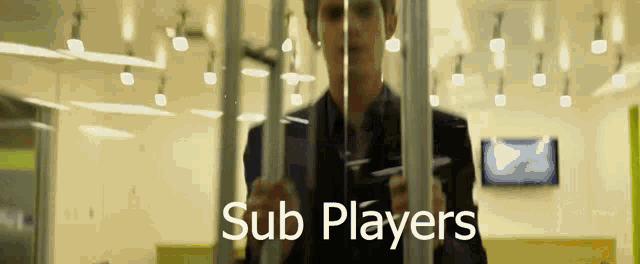 a man in a suit and tie is behind bars with the words sub players written below him