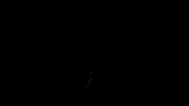 a man in a black t-shirt is holding a remote control