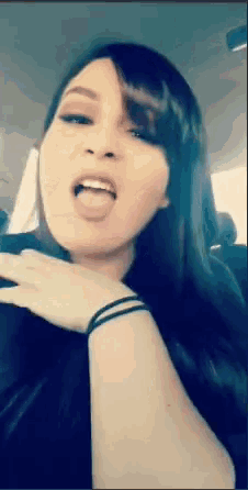 a woman in a car with her tongue hanging out