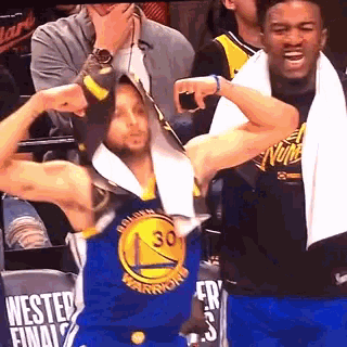 a golden state warriors player is flexing his muscles