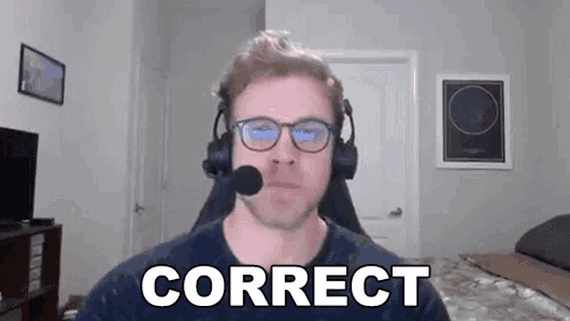 a man wearing headphones and glasses is sitting in front of a camera with the words correct written on the screen .