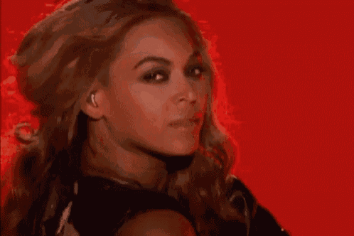 a close up of a woman 's face with a red background