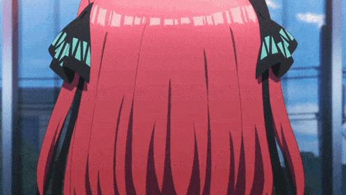 a close up of a person 's red hair with a blue stripe