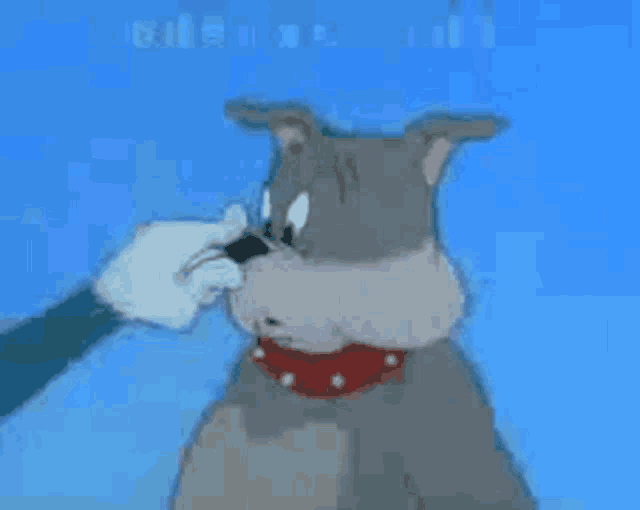 a cartoon dog with a red collar is being licked by a person 's hand .