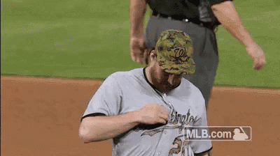 a man wearing a washington nationals jersey is getting ready to play baseball