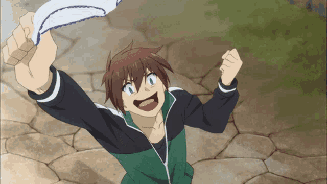 a boy in a green and black jacket is holding up a white cloth