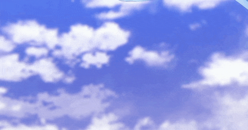 a plane is flying through a blue sky with white clouds .