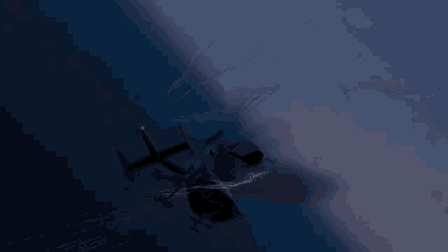 a helicopter is flying over a body of water at night