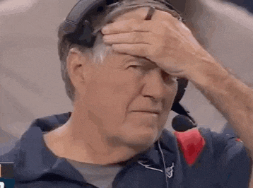 a man wearing a headset is holding his head .