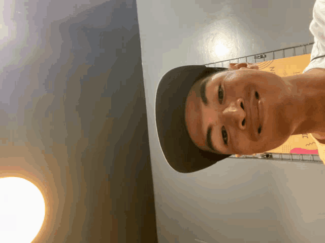 a man wearing a black hat is smiling and looking up