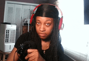 a woman with dreadlocks wearing headphones holds a camera