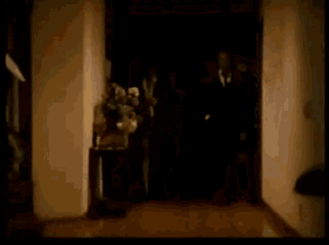 a lamp is lit up in a dark hallway