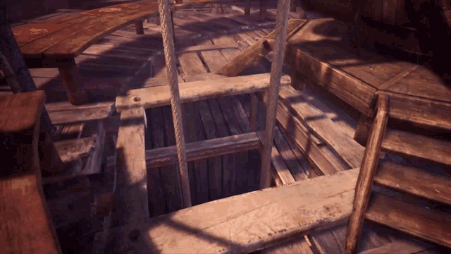a wooden staircase with a rope going up to the top