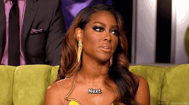 a woman with a necklace that says next on it