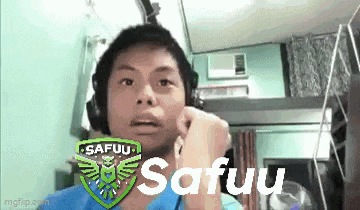 a man wearing headphones is making a funny face while talking on a cell phone .
