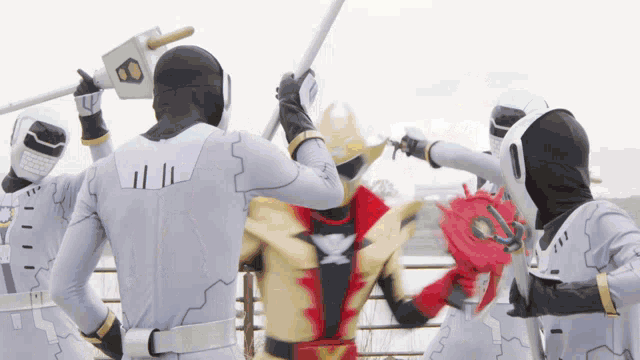 a group of superheros are fighting each other with weapons