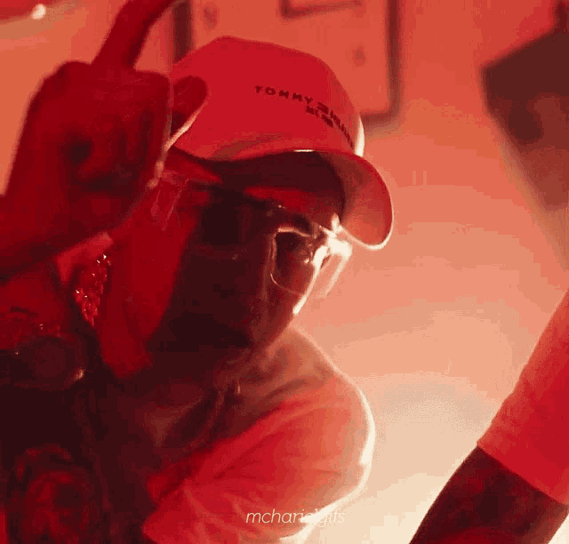 a man wearing a white hat that says tommy hilfiger on it