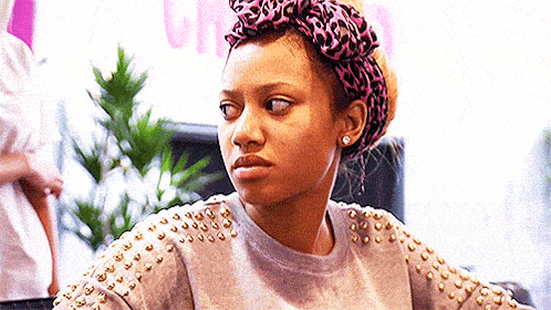 a woman wearing a leopard print headband and studded sleeves