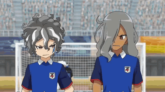 a couple of anime characters standing next to each other with one wearing a blue shirt with a shield on it
