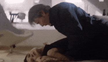 a man and a woman are laying on the floor .