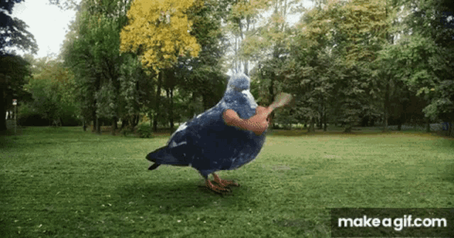 a pigeon is holding a spoon in its beak in a park .