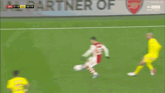 a soccer player with the number 14 on his jersey is dribbling the ball