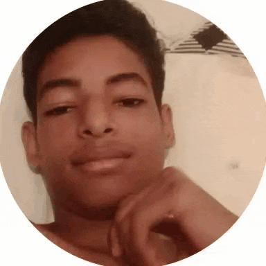 a young man without a shirt is smiling in a circle with his hand on his chin .