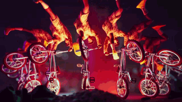 a man is doing a handstand on a bicycle with a red background