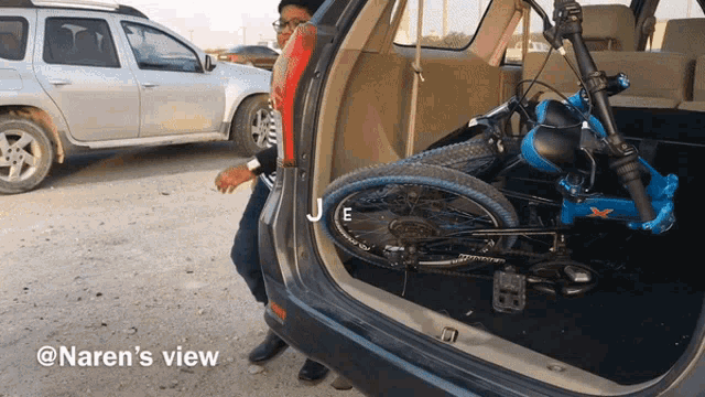 a picture of a bicycle in the back of a car taken by naren