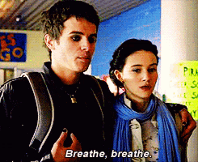 a man and a woman are standing next to each other and the woman is saying breathe breathe