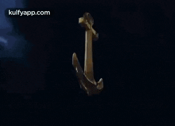 an anchor is floating in the water with a dark background .