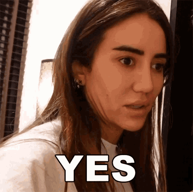 a woman 's face is shown with the word yes written below it