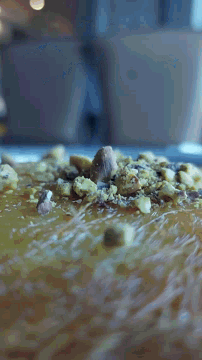 a close up of a cake with nuts on top