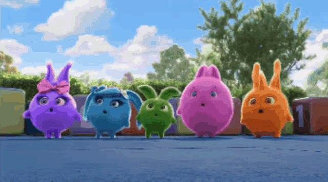 a group of colorful rabbits are standing next to each other in a row