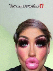 a woman with a lot of makeup on her face and big pink lips