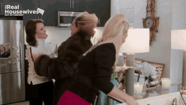 a group of women are standing in a kitchen with the words real housewives out of context on the bottom
