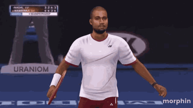 a tennis player is holding a racquet in front of a sign that says uranium