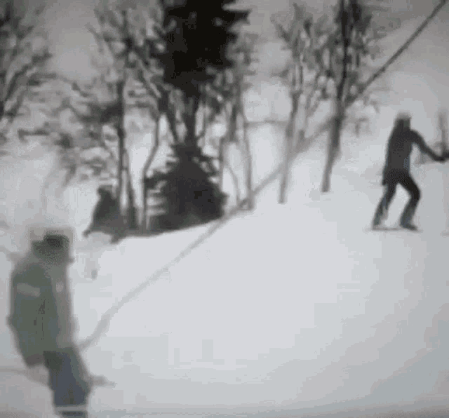 a person in a green jacket is skiing down a snowy hill