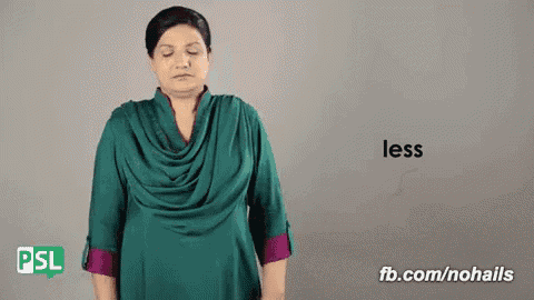 a woman wearing a green shirt is making a gesture that says less