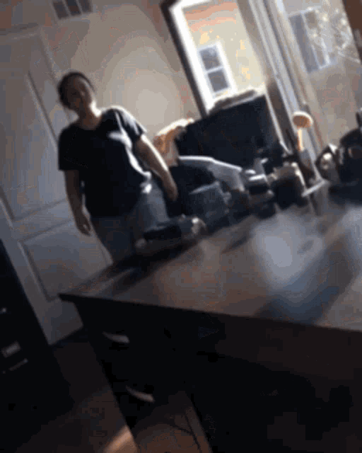 a blurry picture of a woman standing in front of a counter