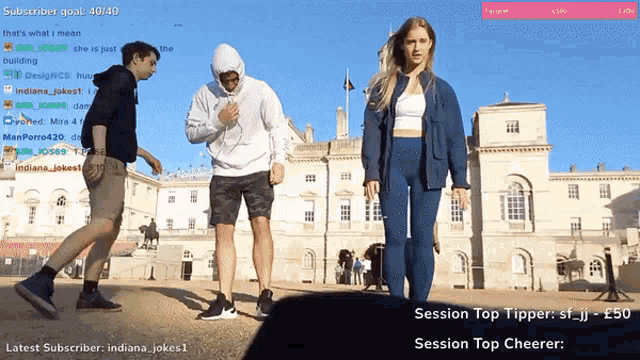 a group of people standing in front of a building with a subscriber goal of 40/40 on the bottom