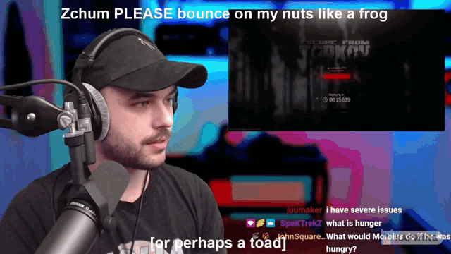 a man wearing headphones talks into a microphone in front of a screen that says zchum please