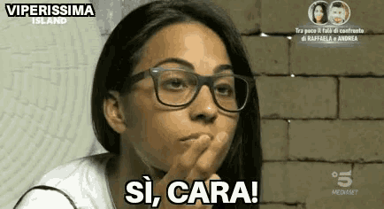 a woman wearing glasses is making a funny face and saying si cara !