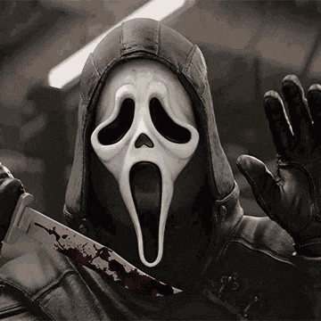 a person wearing a scream mask and holding a bloody knife .